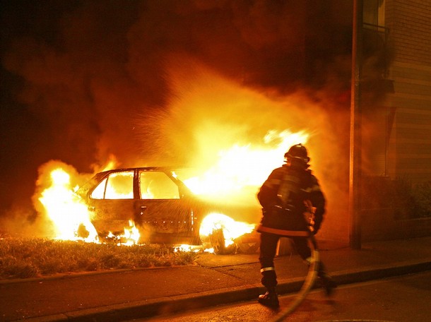 A fireman tries to extinguish a car set ablaze by demonstrators protesting over right-wing (UMP) candidate Nicolas Sarkozy's triumph in presidential elections, 07 May 2007 in the French northern city of Lille. Youths clashed with police in French cities for the second night running 07 May as they staged violent protests over rightwinger Nicolas Sarkozy's triumph in presidential elections. Some 500 people went on a rampage in the Bastille area of eastern Paris, toppling motorbikes and smashing the windows of shops and telephone cabins. Riot police charges eventually forced the crowd to disperse. Pursuits of small gangs continued into the night.    AFP PHOTO PHILIPPE HUGUEN (Photo credit should read PHILIPPE HUGUEN/AFP/Getty Images)